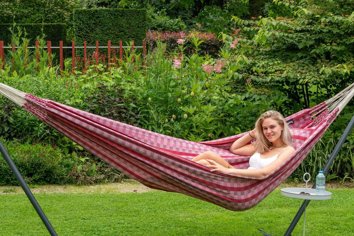 Person relaxing in a hammock in a peaceful garden